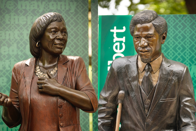 The statues of Baylor's first Black graduates, Barbara Walker (left) and Robert Gilbert (right), are revealed outside Tidwell Bible Building. Grace Everett | Photographer