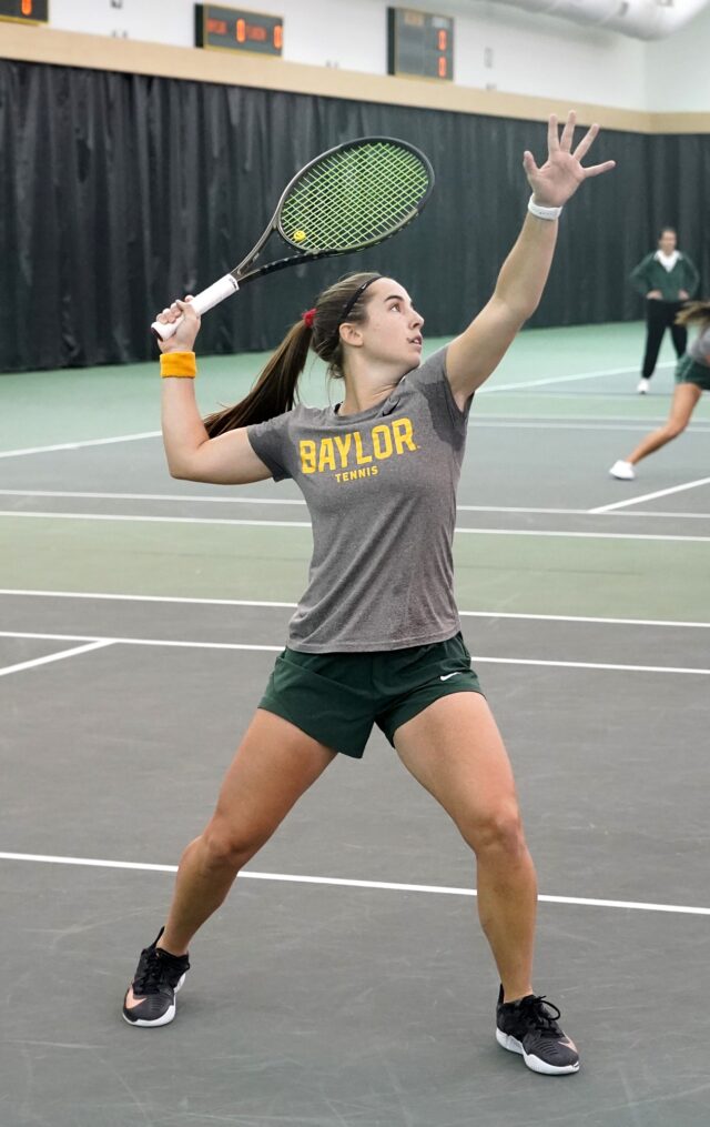 Fifth-year senior Paula Barañano lasers in on the ball before killing it downward during a non-conference match against No. 18 University of Florida on Feb. 5 in the Hawkins Indoor Tennis Center. Grace Everett | Photographer