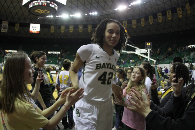 Junior forward women’s basketball player Brittney Griner (42) high fives fans following her dominant 41-point game against Iowa State University on March 3, 2012, in the Ferrell Center. Baylor Roundup file photo