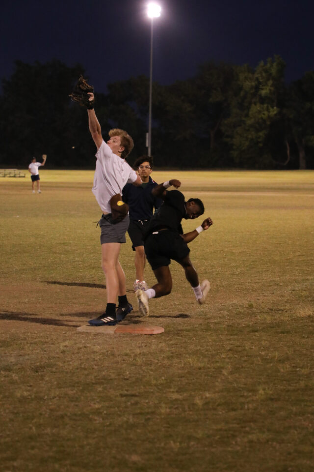 Student getting running to first base during Intramural softball game. Assoah Ndomo | photographer