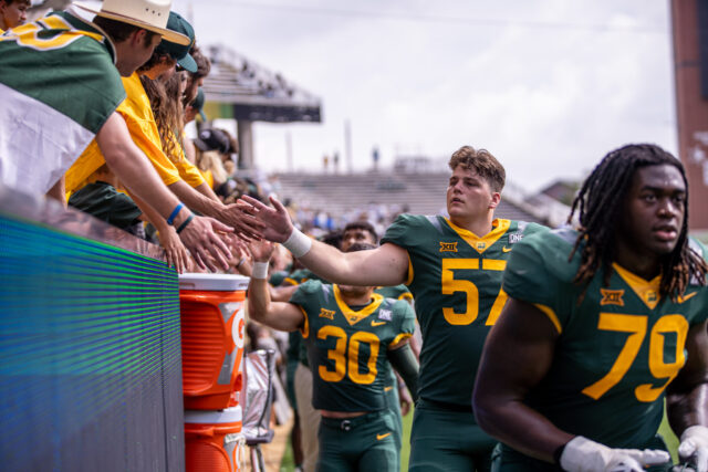 The Baylor football team celebrates with fans following Baylor football's 30-7 win over FCS-member Long Island on Saturday at McLane Stadium. Lilly Yablon | Photographer