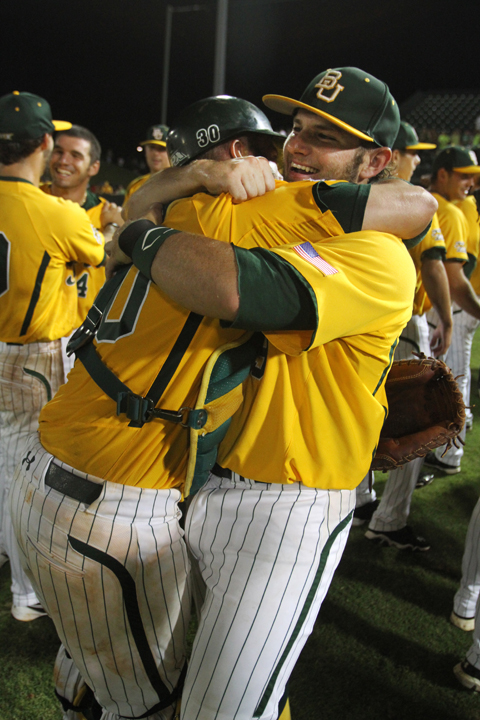 Catcher Josh Ludy hugs first baseman Max Muncy after the Bears' 9-2 victory over Dallas Baptist, claiming the NCAA Regional Championship on Monday, June 4, 2012, at the Baylor Ballpark. Lariat file photo