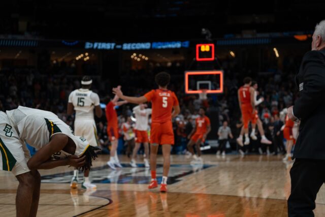 Freshman guard Ja'Kobe Walter (left) buries his face in his jersey as the clock strikes zero of No. 3 seed Baylor men's basketball's loss to No. 6 seed Clemson on Sunday in the FedExForum. Camie Jobe | Photographer