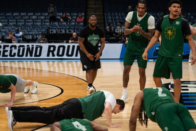 Head coach Scott Drew takes part in the losing team's push-up punishment during a team practice on Thursday in the FedExForum in Memphis, Tenn.
