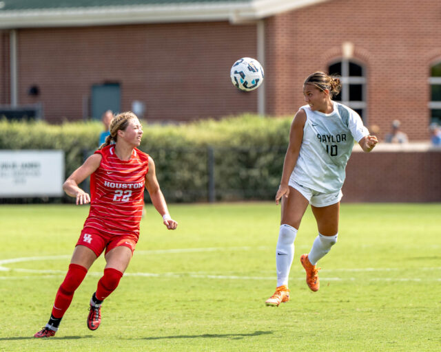 Junior midfielder Hannah Boughton leaps after the ball during Baylor soccer's 4-0 win over Houston Sunday afternoon at Betty Lou Mays Field. Kassidy Tsikitas | Photographer