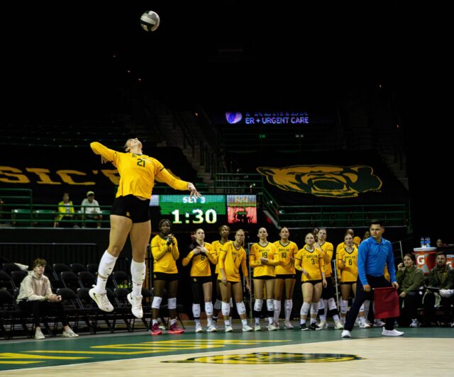 Senior outside hitter Elise McGhee flys as she hits an ace during the match against UCF on Saturday at Ferrel Center. Cameron McCollum | Photo Editor