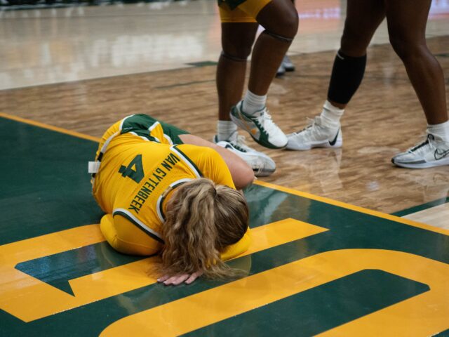 Graduate student guard Jana van Gytenbeek lays on the court after her in game injury during the Incarnate Ward game Thursday. Cameron McCollum | Photo Editor