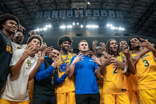 Fifth-year forward Norchad Omier celebrates with teammates after being named MVP during No. 8 Baylor men's basketball's 72-67 win on Saturday night at the American Airlines Center. Kassidy Tsikitas | Photo Editor