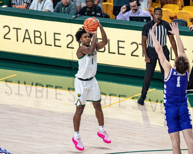 Freshman guard Robert Wright III puts up a three-pointer during No. 12 Baylor men's basketball's 104-41 win on Sunday night at the Foster Pavillion. Kassidy Tsikitas | Photo Editor