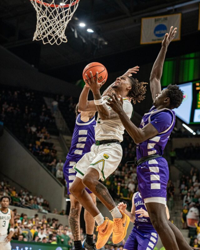 Senior guard Jayden Nunn maneuvers through contact during No. 12 Baylor men's basketball's 104-41 win on Sunday night at the Foster Pavillion. Kassidy Tsikitas | Photo Editor