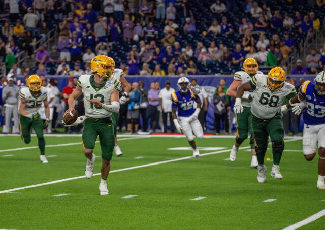 Redshirt junior quarterback Sawyer Robertson rolls out of the pocket during Baylor football's 44-31 Kinder's Texas Bowl loss to LSU Tuesday at NRG Stadium in Houston. Mary Thurmond | Photo Editor