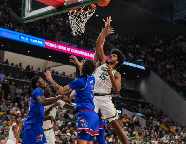 Fifth-year forward Norchad Omier tosses up a shot during Baylor men's basketball's 81-70 win over No. 11 Kansas Saturday afternoon at Foster Pavilion. Caleb Garcia | Photographer