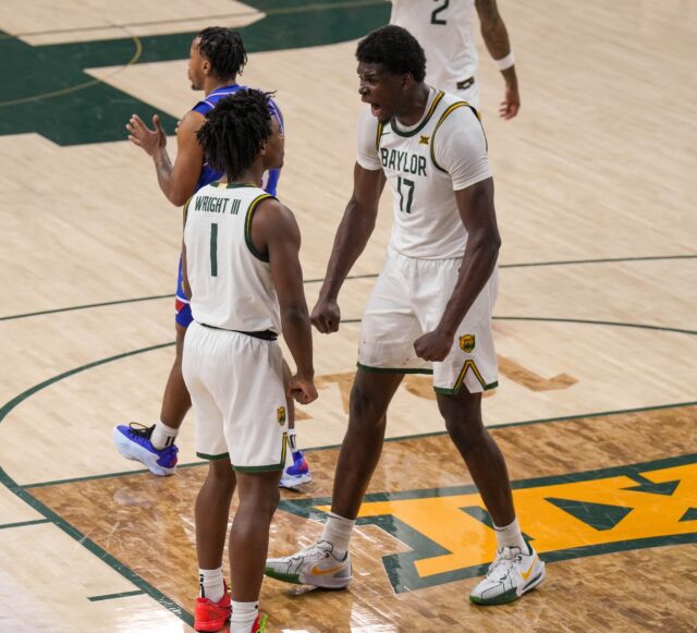 Junior guard Josh Ojianwuna congratulates freshman guard Robert Wright III after