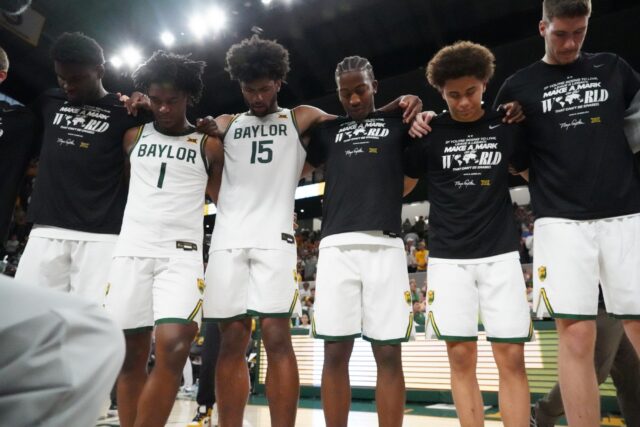 Players pray together after their victory against Kansas, following an amazing comeback from