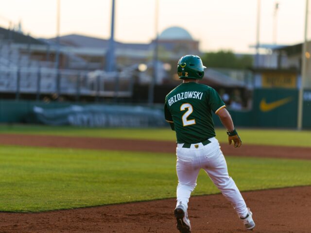 Sophomore left fielder Gavin Brzozowski rounds first after sending a line drive into the outfield in the Bears' 13-4 win against UTA at Baylor Ballpark. Brady Harris | Photographer