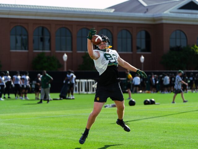 Redshirt Junior Cody Mladenka going up for a jump ball during the tight ends' route running segment of their individual period in Tuesday's spring practice at the Baylor Football practice field. Brady Harris | Photographer