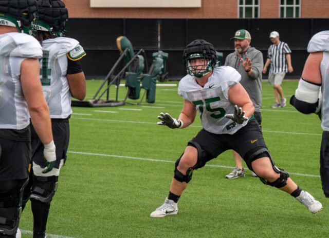 Freshman offensive lineman Harrison Cluff assumes a pass protection stance during Baylor football’s spring practice at the Baylor Football Practice Field on Thursday afternoon. Mary Thurmond | Photo Editor