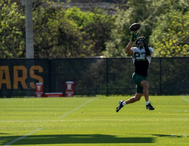 Sophomore wide receiver Jadon Porter leaps to catch a pass during a high-pointing drill at Baylor football’s spring practice at the Baylor Football Practice Field on Thursday afternoon. Mary Thurmond | Photo Editor
