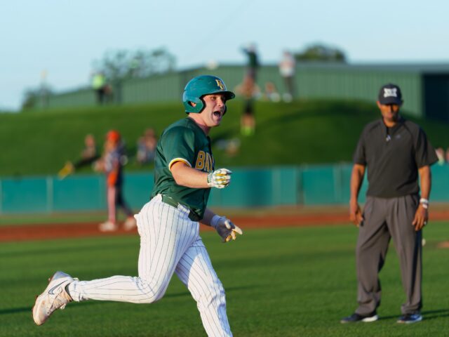 Senior catcher Cortlan Castle pumps his fist towards the dugout while he rounds the bases after hitting a grand slam in the bottom of the third in the Bears' win against UTRGV Tuesday night at Baylor Ballpark. Brady Harris | Photographer