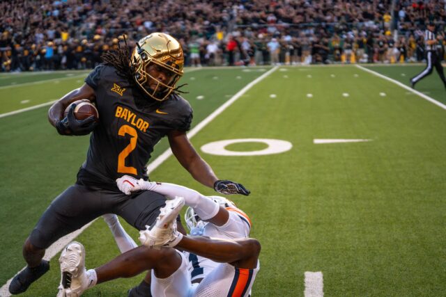 Senior wide receiver Kole Wilson attempts to evade a tackle during Baylor football's 38-24 loss against Auburn on Friday night at McLane Stadium. Mary Thurmond | Photo Editor