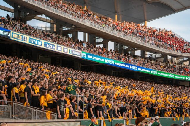 Baylor students wave their line jerseys in the air after celebrating a field goal during Baylor football's 38-24 loss against Auburn on Friday night at McLane Stadium. Mary Thurmond | Photo Editor