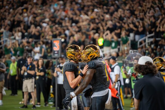 Redshirt senior quarterback Sawyer Robertson and redshirt senior tight end Michael Trigg celebrate after a touchdown during Baylor football's 38-24 loss against Auburn Friday night at McLane Stadium. Sam Gassaway | Photographer