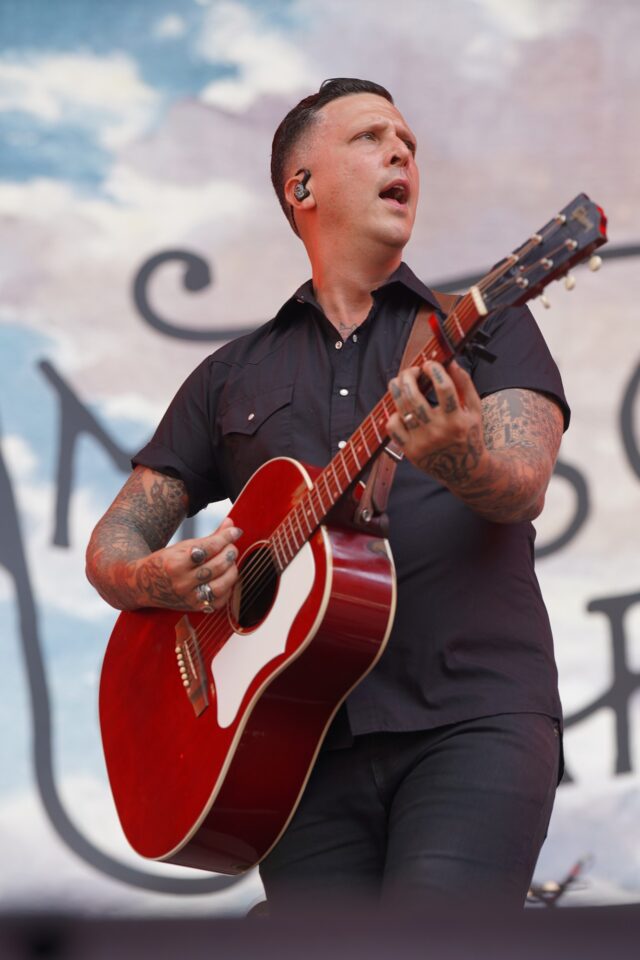 Lead Singer of American Aquarium, BJ Burnham sings their debut piece, "I Hope He Breaks Your Heart" at the Boys from Oklahoma Concert at Mcclane Stadium . Caleb Garcia | Photographer