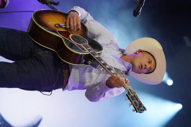 Evan Feller, lead singer of the Turnpike Troubadors, plays their heartfelt piece, "Adeline" at the Boys From Oklahoma concert at Mclane Stadium. Caleb Garcia | Photographer