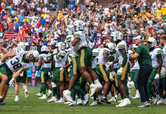 Baylor players celebrate after the game-winning field goal during the Bears’ 48-45 double-overtime win over No. 17 SMU Saturday at Gerald J. Ford Stadium in Dallas. Mary Thurmond | Photo Editor