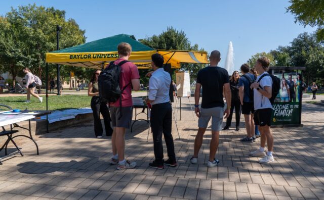 The Waco Metropolitan Planning Organization sets up a tent of fountain mall, awaiting student feedback about their proposal. Sam Gassaway | Photographer