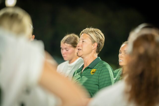 Coach Michelle Lenard debriefs with the players after the Bears' 2-0 victory over ACU on Sunday. Sam Gassaway | Photographer