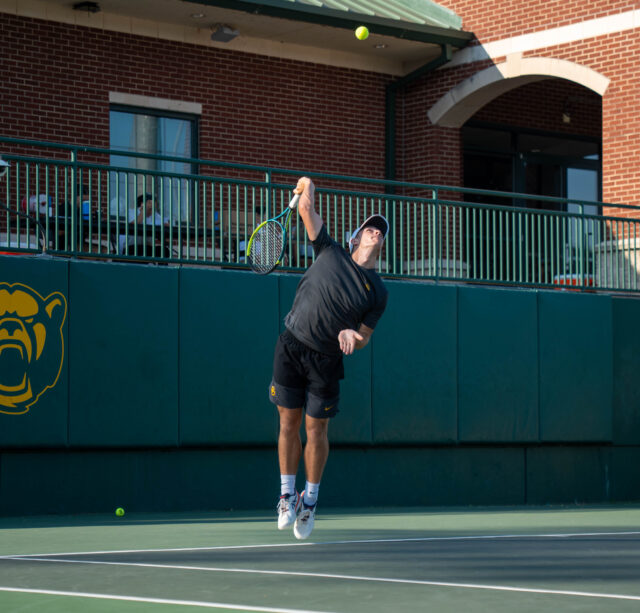 Junior Louis Bowden fires a serve while partnered with senior Arman Zamani in doubles play during Baylor’s 8-6 win over Texas Tech. Mary Thurmond | Photo Editor