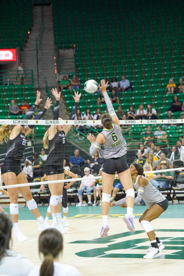 Freshman Outside Hitter Kseniya Rakmanchyk spikes a ball at the Baylor vs Northwestern University volleyball game at Ferrell Center. Caleb Garcia | Photographer
