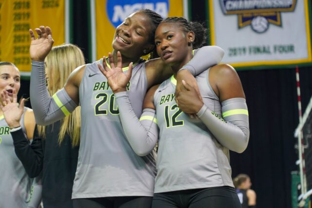 Grad student Middle Blocker Manuela Bibinbe and Redshirt Junior Outside Hitter Brielle Warren throw up a Sic Em' after a hard earned victory against Northwestern University at the Ferrell Center. Caleb Garcia | Photographer