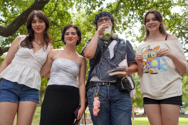 The winner of the Performative Male contest poses with judges and the grand prize of a single dollar Friday afternoon at Vera Daniel Plaza. Caleb Garcia | Photographer