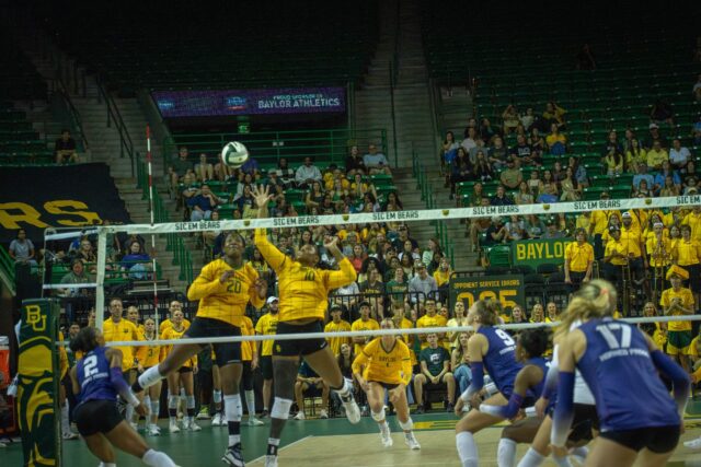 Graduate middle blocker Gabrielle Essix and graduate middle blocker Manuela Bibinbe block TCU's ball during the Bears' 3-2 victory over TCU at the Ferrell Center on Saturday. Sam Gassaway | Photographer
