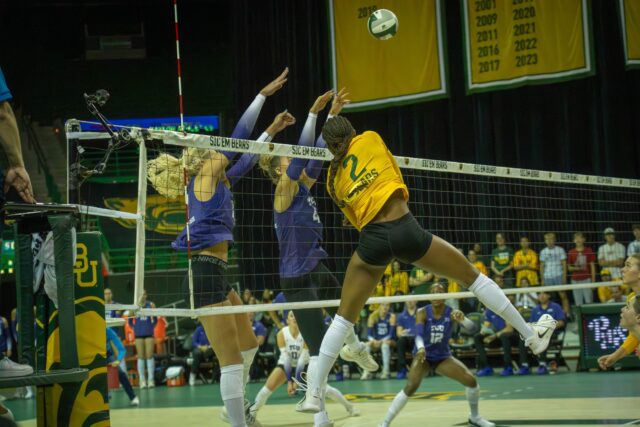 Freshman outside hitter Bailey Warren hits the ball over the net during the Bears' 3-2 victory over TCU at the Ferrell Center on Saturday. Sam Gassaway | Photographer