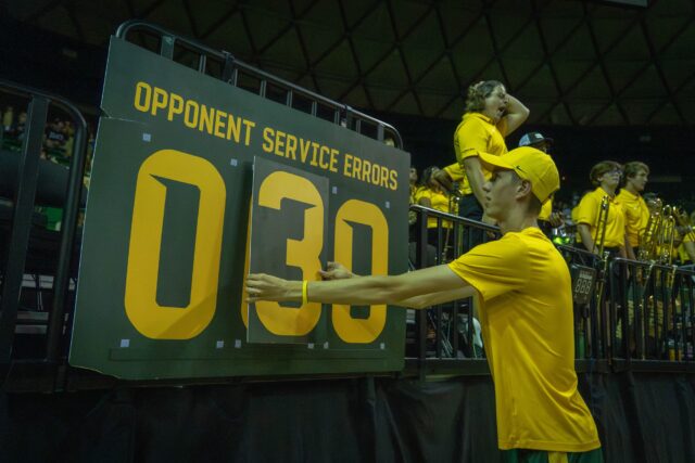 Senior Tryston McGuyre updates the "opponent service errors" board at the Bears&squot; 3-2 victory over TCU at the Ferrell Center on Saturday. Sam Gassaway | Photographer