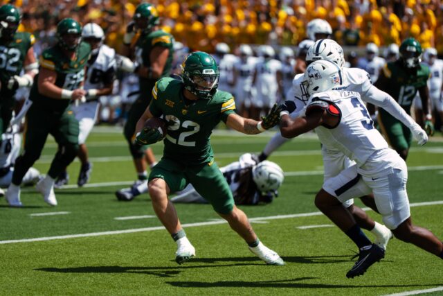 Freshman running back Caden Knighten stiff arms a defender while powering towards the end zone in the Bears' 42-7 victory over Samford Saturday at McLane Stadium. Brady Harris | Photographer