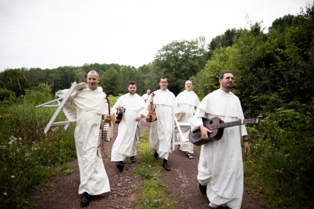 Dominican friars with instruments in hand head to a recording session in the Catskill Mountains. The Hillbilly Thomists, a bluegrass band made up of Catholic priests, blend the Americana and folk music tradition into their vocations. Image credit Paul Padgett.