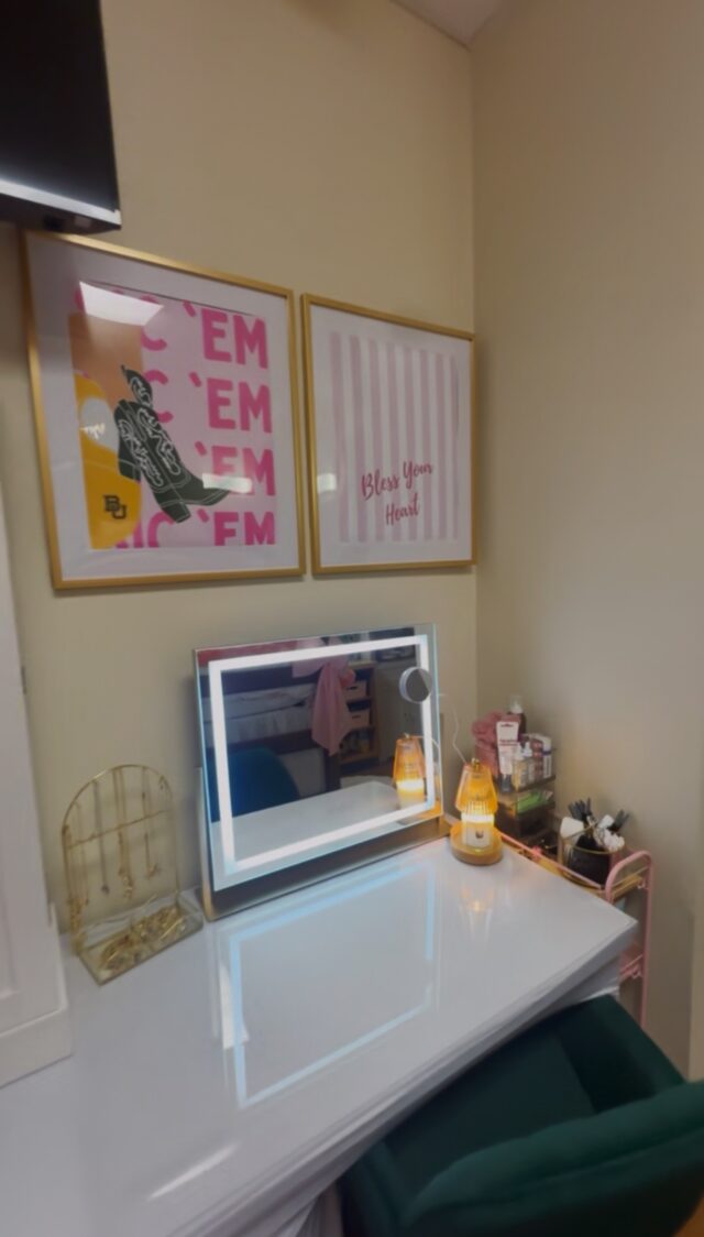 Lunsford's desk area contains a light-up vanity, pink Baylor-themed posters, and a service cart for storage. Photo courtesy of Linkynn Lunsford