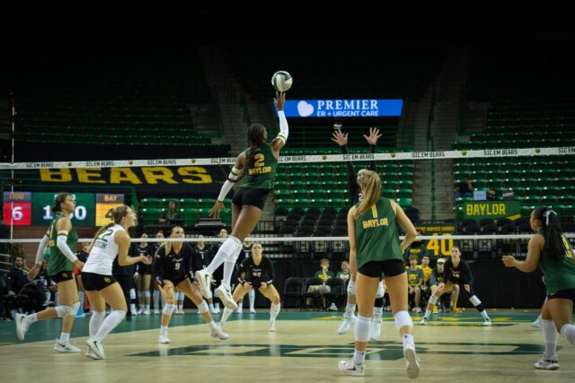 Freshman outside hitter Bailey Warren hits the ball over the net during the Bears' 3-0 victory over Houston at the Ferrell Center on Wednesday. Sam Gassaway | Photographer