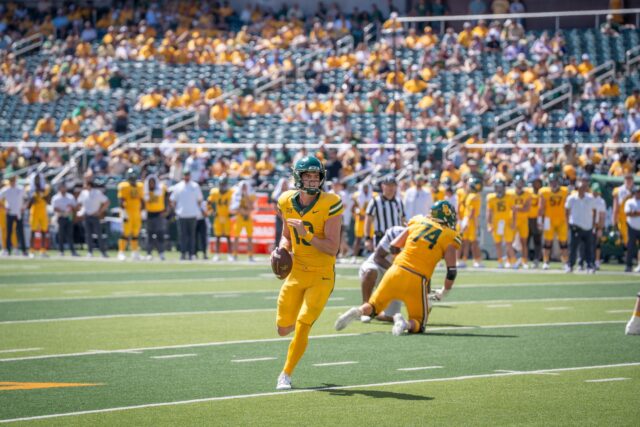 Redshirt senior quarterback Sawyer Robertson runs the ball during the Bears' 35-34 victory over Kansas State. Sam Gassaway | Photographer
