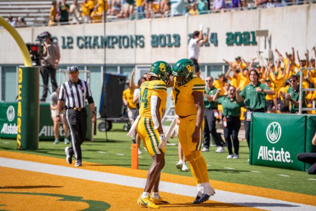 Redshirt senior wide receiver Josh Cameron and redshirt sophomore running back Bryson Washington embrace after a touchdown against Kansas State. Sam Gassaway | Photographer