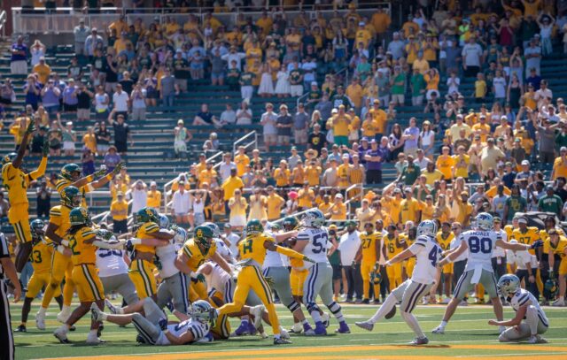 Redshirt senior defensive lineman Cooper Lanz swats Kansas State's kick to secure the Bears' victory. Sam Gassaway | Photographer