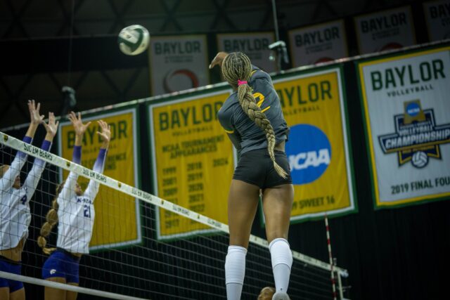Freshman outside hitter Bailey Warren hits the ball over the net during the Bears' 3-1 victory over Kansas State at the Ferrell Center on Wednesday. Sam Gassaway | Photographer