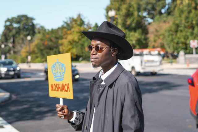 A man walks the streets by the capital bearing a sign stating Moshiach, the Hebrew word for Messiah Thursday morning in Washington, D.C. Jake Schroeder | Photographer