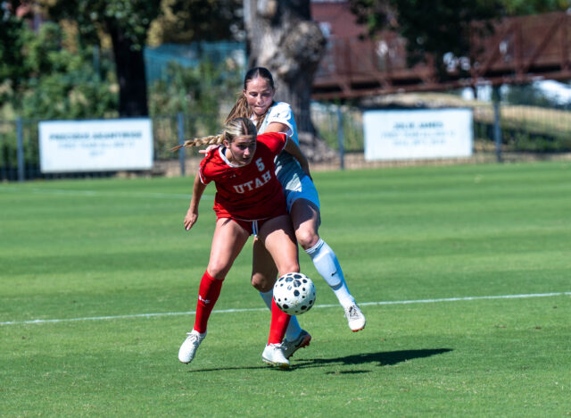 Graduate defender Blythe Obar fights for the ball with Utah midfielder Grace Watkins. Mary Thurmond | Photo Editor