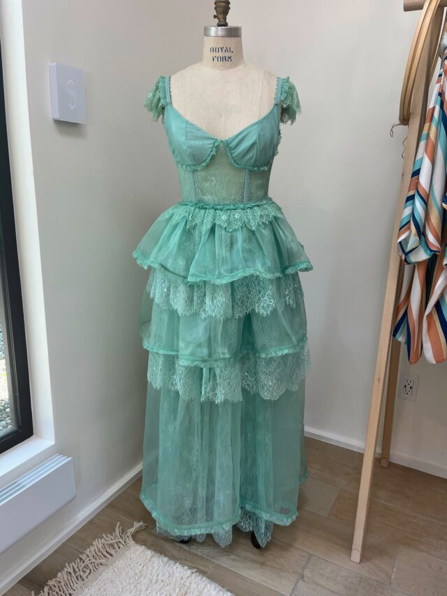 Caitlynn Reynolds’ handmade prom dress, sewn during high school, marked the beginning of her passion for design. The layered tulle and lace gown reflects the whimsical, romantic aesthetic that would later shape her fashion collection in Paris.