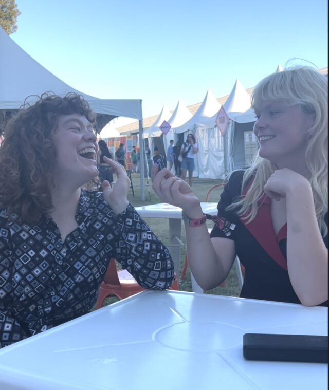 Kenzie and Laila laugh as they discuss